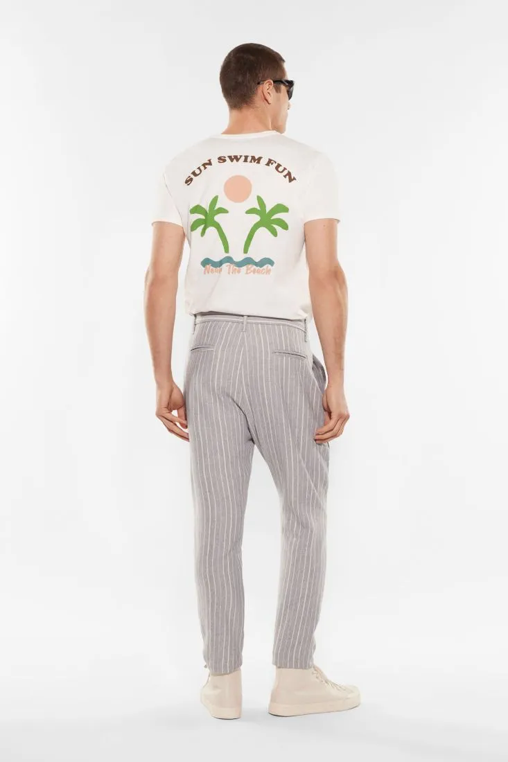 Pantaloni slim-fit fantasia gessata con catena